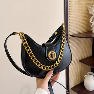 Fashionable black hobo crescent shoulder bag with chunky gold chain and leather strap