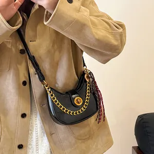 Chic black crescent shoulder bag with golden chain and metallic buckle for women