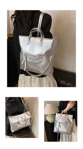 Silver metallic convertible backpack and tote with motorcycle-style studs and long tassels