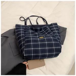 Blue and white checkered tote bag with Handmade label showing spacious interior and phone size