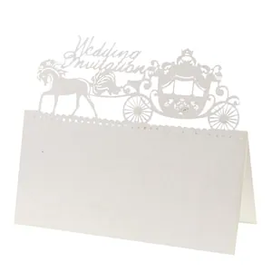 Detailed laser-cut white wedding place card with a carriage design and intricate lace pattern