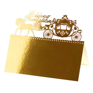 Detailed laser-cut gold wedding table card featuring a royal carriage and horses