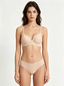 Detail of seamless wireless lingerie set with soft support and thin straps in beige