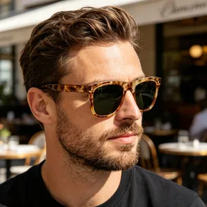 Close-up of man wearing stylish tortoiseshell polarized sunglasses in sunlight