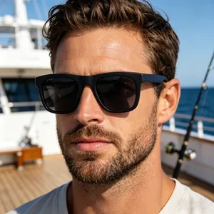 Close-up shot of a man wearing classic black polarized sunglasses on a yacht deck