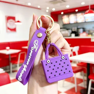 Close-up of purple EVA beach bag keychain with Forever Love wristlet and gold hardware