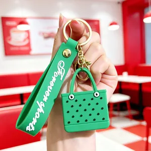 Close-up of vibrant green EVA mini beach bag keychain with golden ring and wristlet