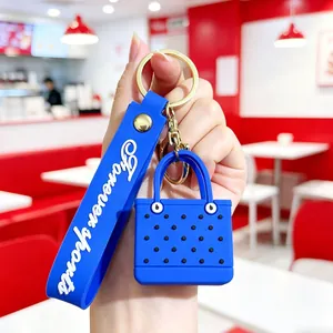 Blue silicone wristband with mini beach bag charm and golden metal hardware