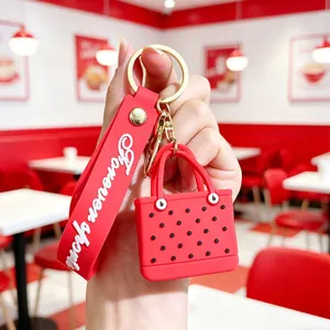 Detail of red EVA tote bag keychain with Forever Young wristlet and polka dot charm