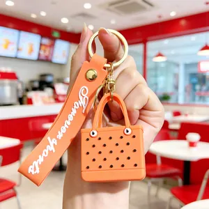 Detail of orange EVA beach bag keychain with Forever sports strap and gold metal clasp