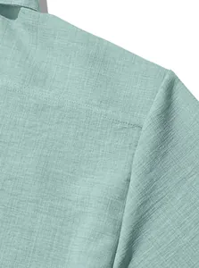 Detailed macro view of mint green linen cotton shirt shoulder seam and breathable fabric