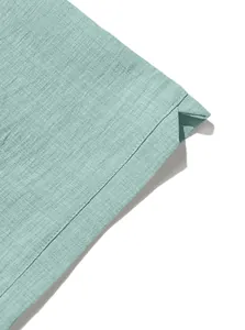 Detailed close-up of light cyan linen fabric texture and premium hem stitching detail