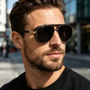 Close-up of stylish pilot sunglasses with black frames and gold accents on male model