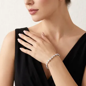 Elegant 4mm round-cut moissanite bracelet in silver-tone finish on female model