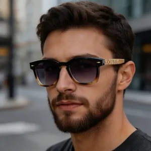 Detail of vintage square sunglasses with gold patterned temples and gradient lenses