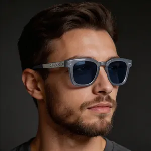 Detail of grey square sunglasses with blue lenses and embossed metal monogram temples