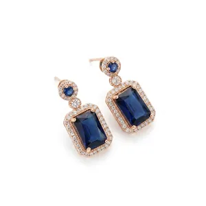 Elegant rose gold drop earrings featuring rectangular blue sapphires with a diamond halo