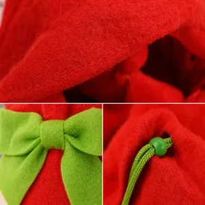 Close-up detail of red felt Christmas wine bottle cover with decorative green bow