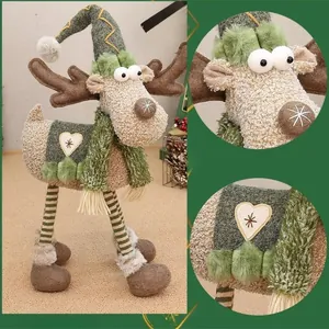 Standing fabric Christmas reindeer figurine with green hat and striped legs for home decor