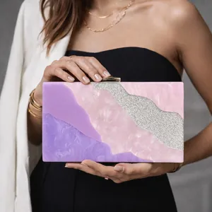 Detail of acrylic clutch featuring purple marble texture and silver glitter patchwork