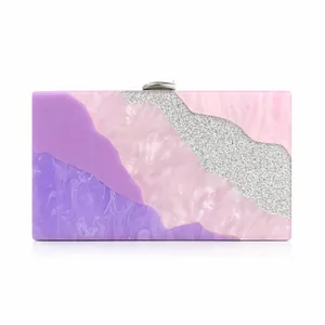 Macro shot of purple marble acrylic evening bag with diagonal silver glitter insert