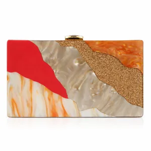 Detail view of the colorful acrylic evening bag with geometric patterns and gold clasp