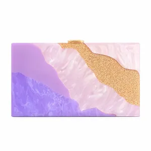 Detail of acrylic marble evening clutch featuring pink and purple mosaic patterns