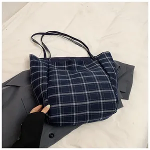 Detail of vintage navy blue plaid tote bag showing canvas texture and spacious interior