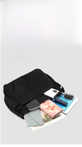 Detail view of black nylon crossbody bag showing compartments and large storage capacity