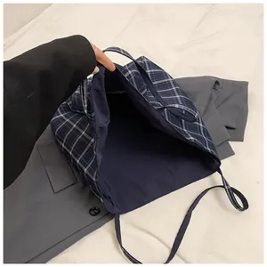 Detailed view of the spacious navy blue checkered tote bag interior and fabric lining