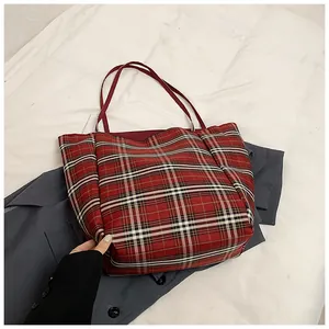 Top view of large plaid tote bag with red, white and black tartan pattern on fabric