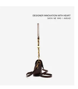 Side view of dark brown leather crossbody bag with gold chain and adjustable strap