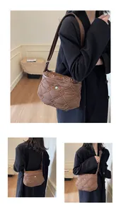 Close-up of brown quilted bag with knotted diamond mesh and adjustable strap