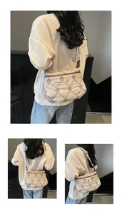 Detailed quilted texture and metallic circular logo on beige crossbody space cotton bag