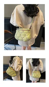 Detailed view of green quilted nylon crossbody bag with adjustable strap and metal logo