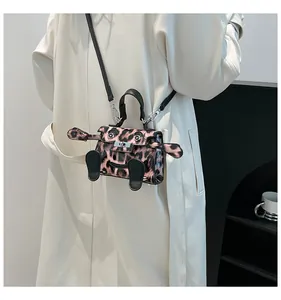 Detail of monster-shaped mini leopard handbag with 3D ears and silver turn-lock