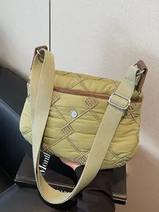 Olive green quilted puffer crossbody bag with spacious design and adjustable strap