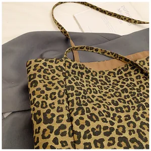 Close-up of leopard print canvas texture and strap stitching on a chic tote bag