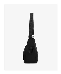 Side view of black nylon crossbody bag with drawstring side pocket and silver metal buckle