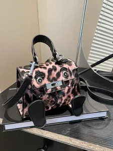 Pink leopard print mini handbag with cute cartoon eyes and crossbody shoulder strap
