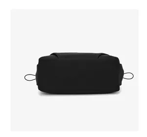 Detail view of the wide rectangular base of this lightweight black nylon shoulder bag