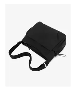 Macro view showing the durable black nylon fabric and multi-pocket design of this leisure bag