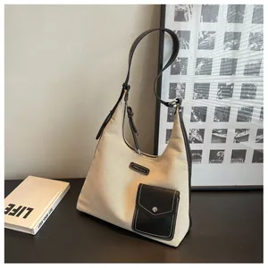 Détails du sac sous le bras en toile avec garniture en cuir noir et boucle en métal