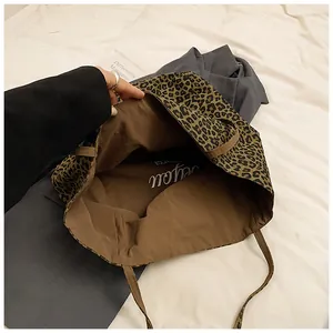 Close-up of leopard print tote bag with brown lining and spacious inner compartment