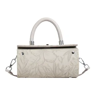Detailed relief flower embossing on cream-white box bag with silver hardware