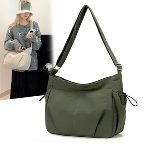 Waterproof nylon crossbody bag in dark green featuring multi-pockets and adjustable strap