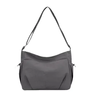 Dark grey nylon crossbody bag with multi-layer pockets and adjustable shoulder strap