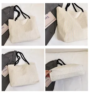 Détail du sac cabas en velours côtelé écru avec anses tressées noires et fond plissé