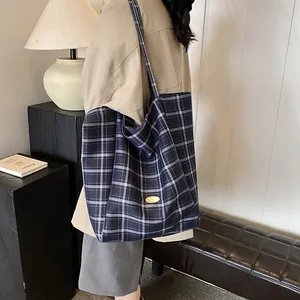 Vintage navy plaid large tote bag with handmade metal plaque shown in a lifestyle setting