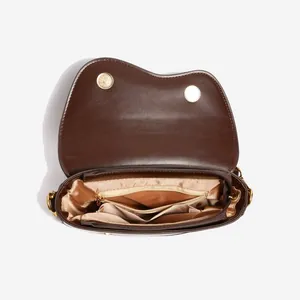 Interior layout of dark brown saddle bag featuring main compartment and zip pocket